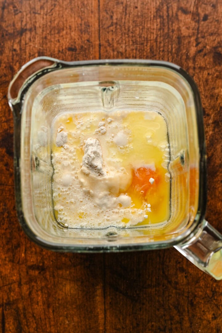 Overhead view of popover ingredients in a blender before blending.
