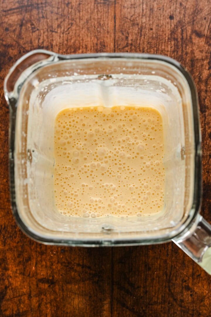 Overhead view of popover ingredients in a blender after blending.
