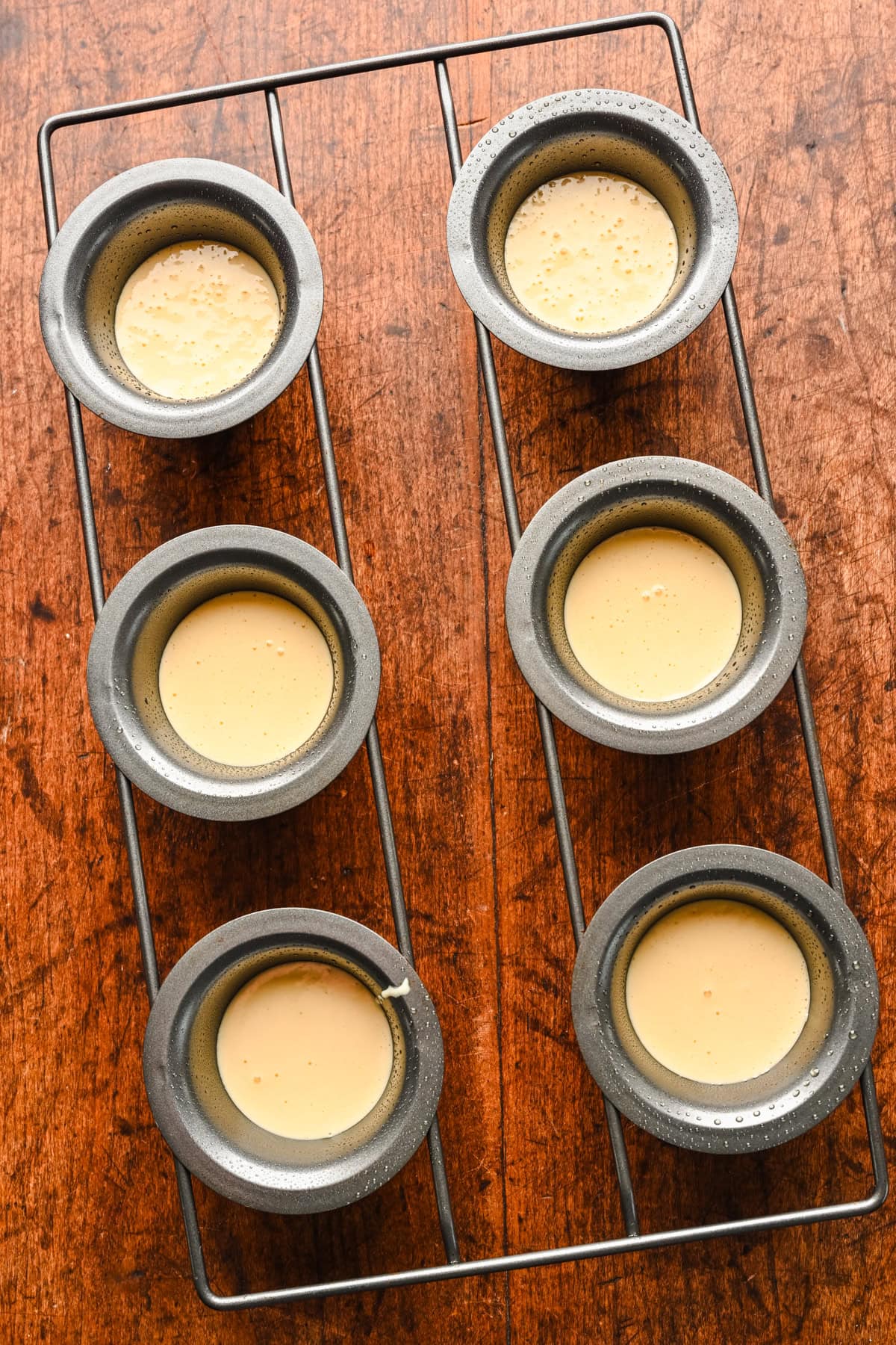 Overhead view of batter poured into a popover pan.
