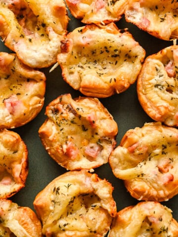Close up overhead view of croque monsieur bites on a platter.