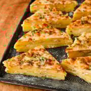 Triangles of potatoes dauphinoise on a platter.