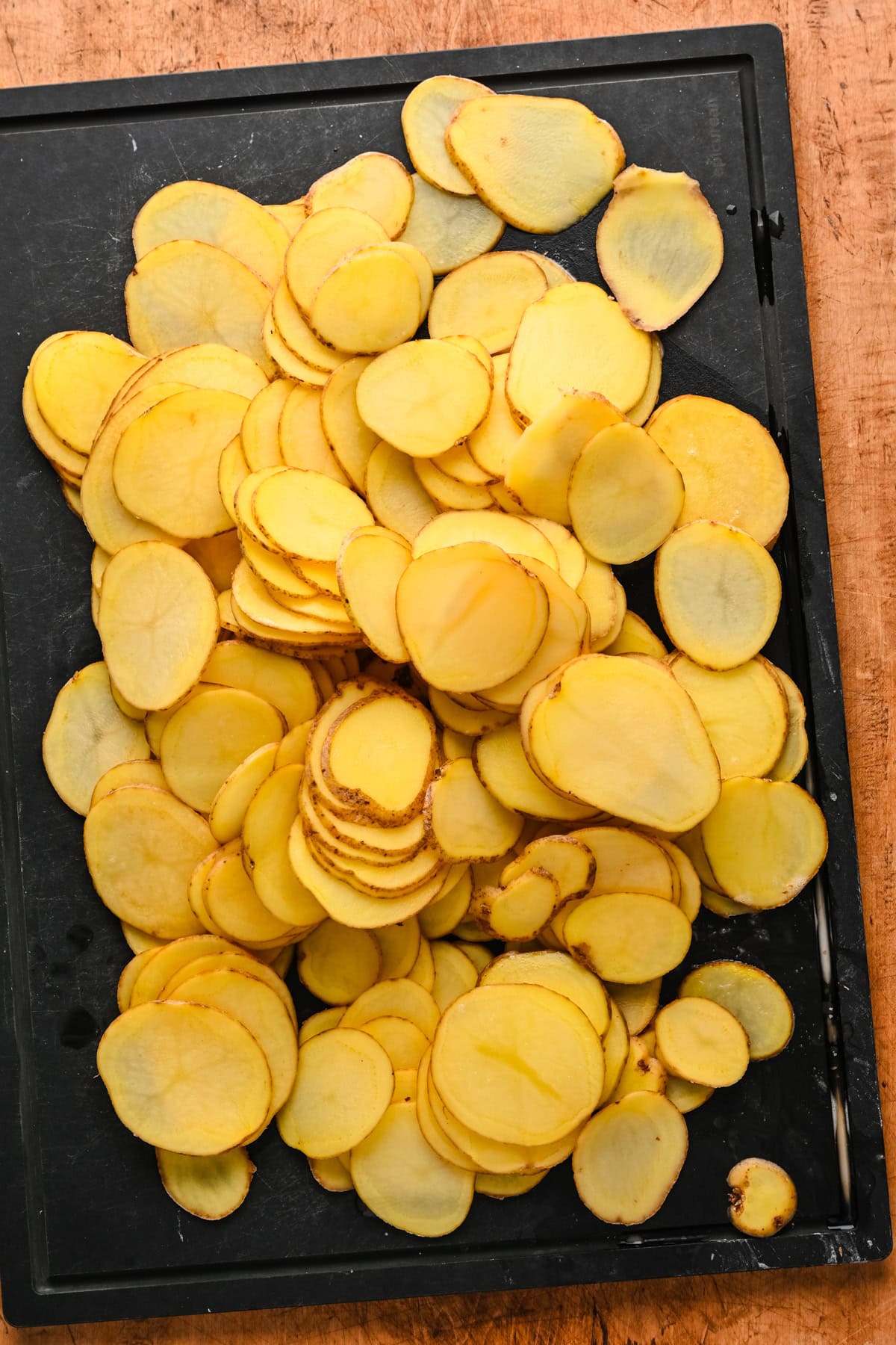 Sliced potatoes on a cutting board.