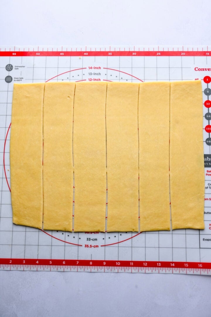 Fan roll dough rolled into a rectangle and cut into 6 strips.