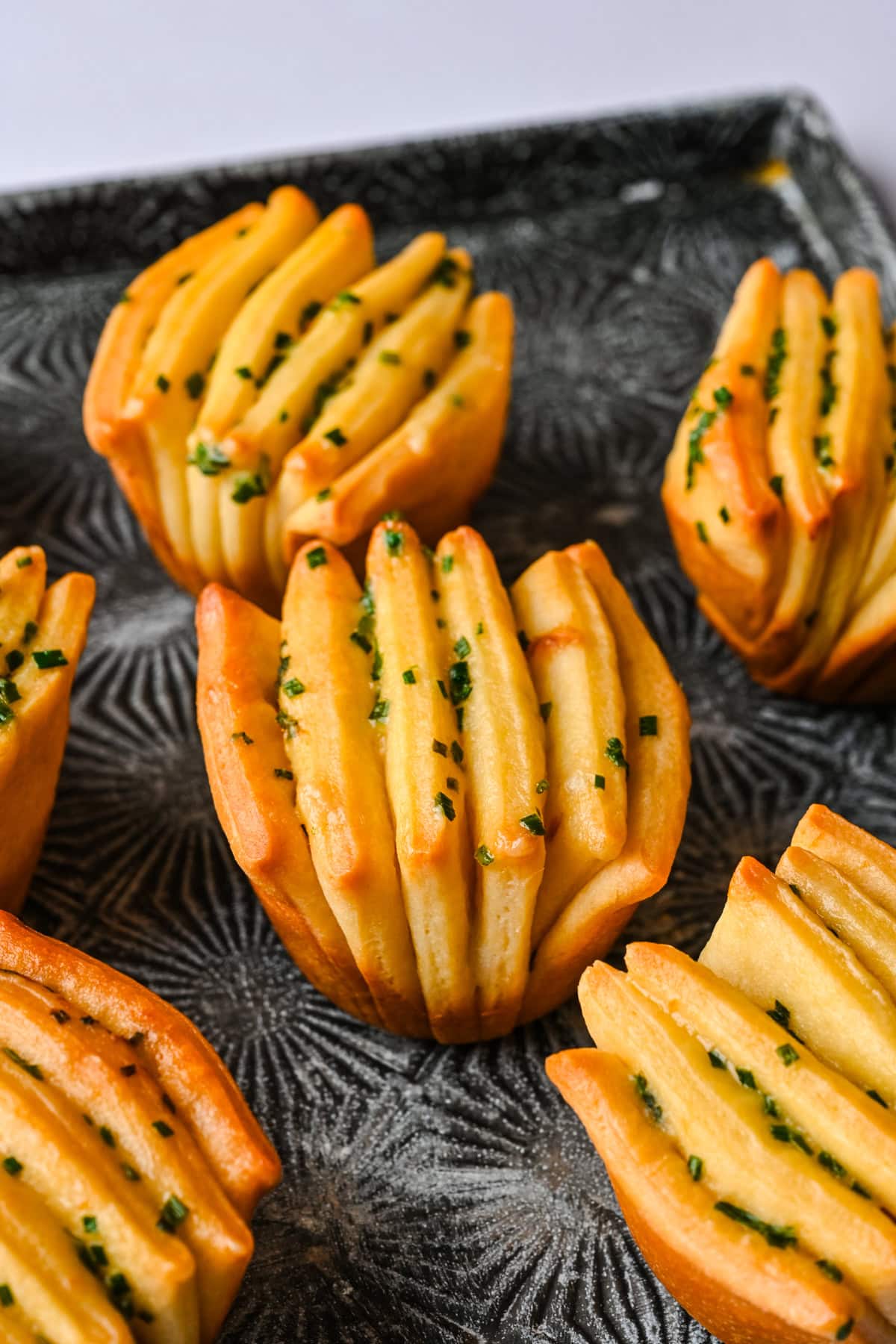 side view of garlic herb butter fan rolls.