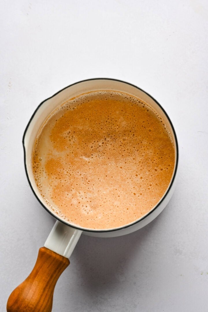 milk, yeast and sugar in a saucepan.