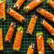 Crispy cheese and chive appetizer sticks on wire rack.