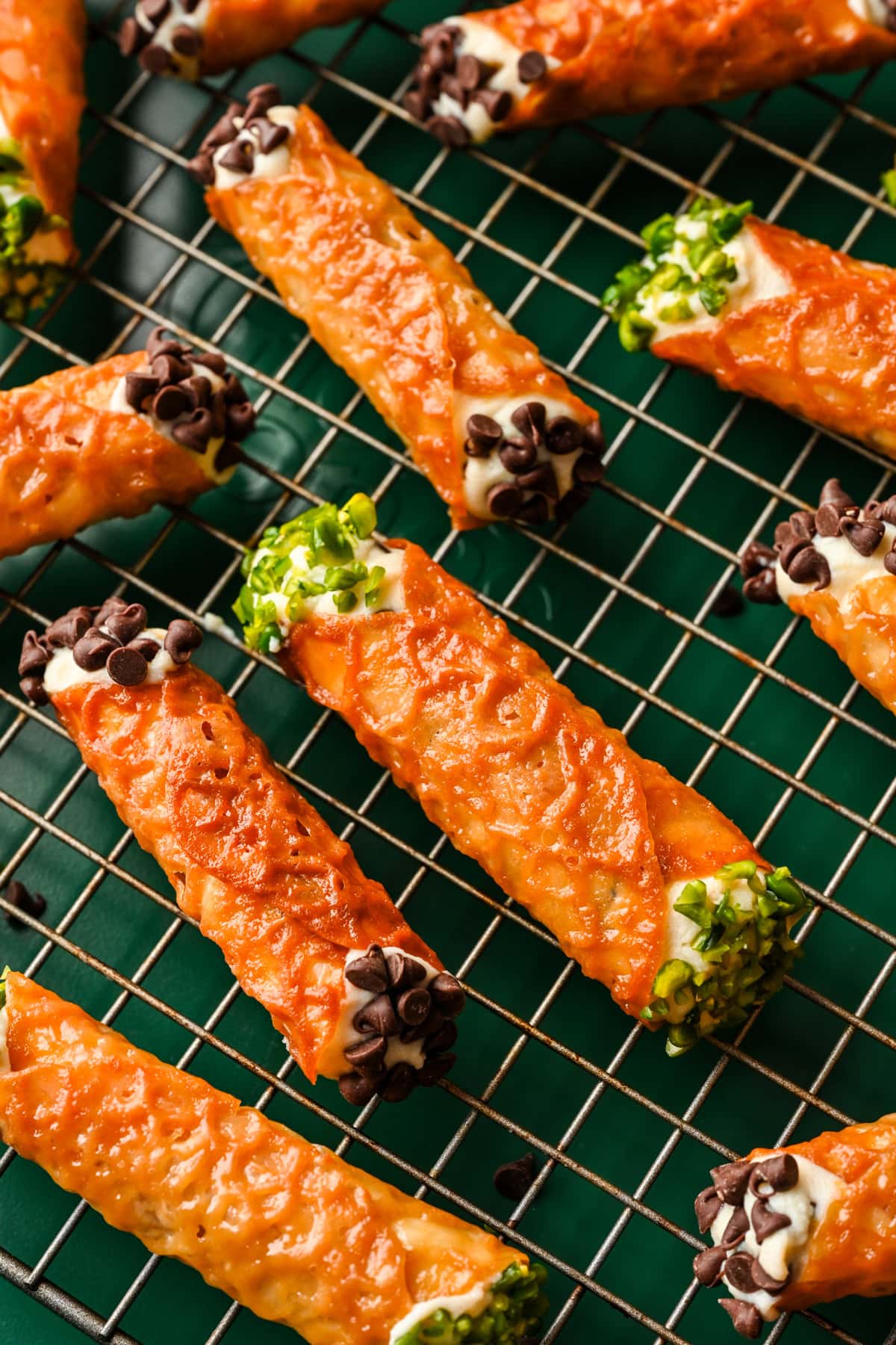 Close up view of florentine cannoli with chocolate chips and pistachios on the ends.