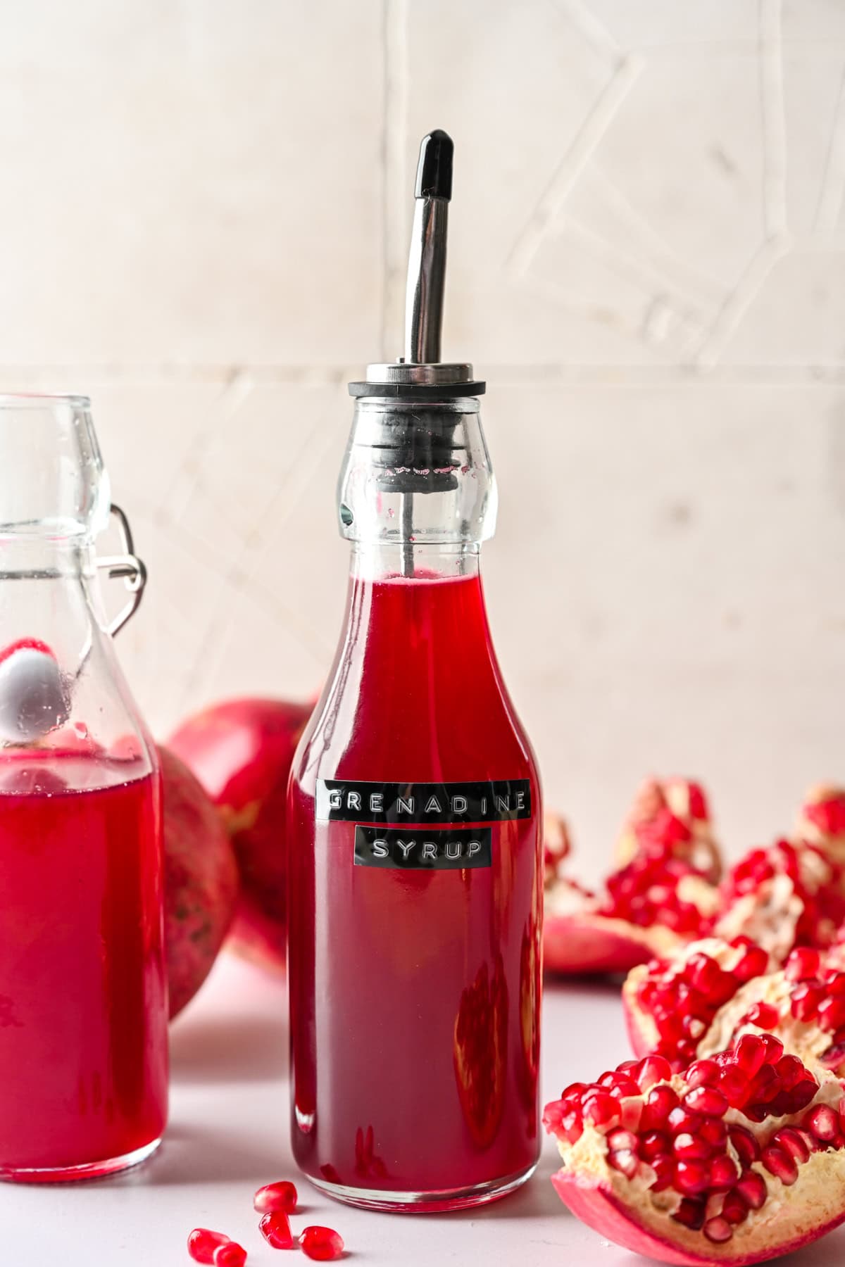 Side view of homemade grenadine in a bottle with label.
