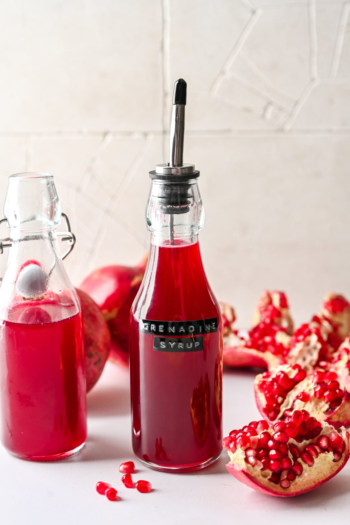 Side view of homemade grenadine in a bottle with label.