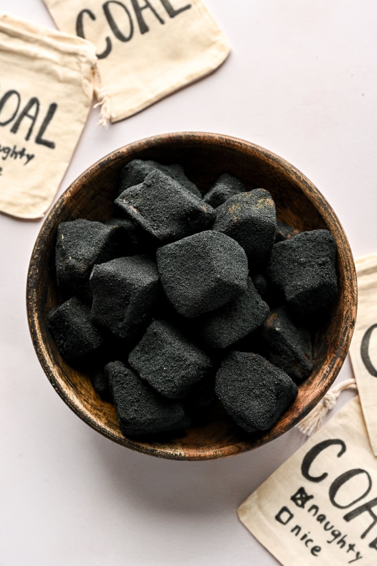 Overhead view of edible coal candy in a bowl.