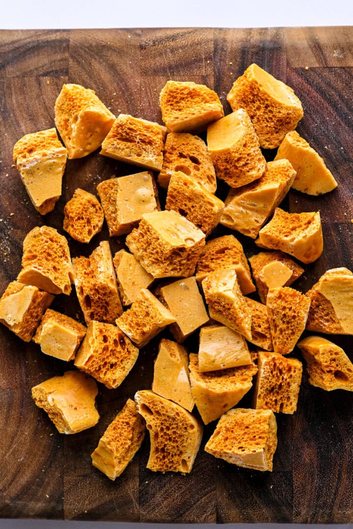 Overhead view of honeycomb candy broken up into smaller pieces.