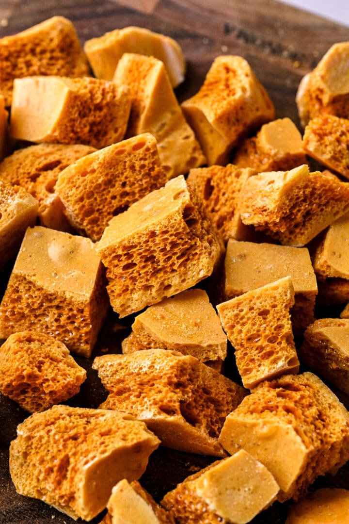 Side view of honeycomb candy broken up into smaller pieces.