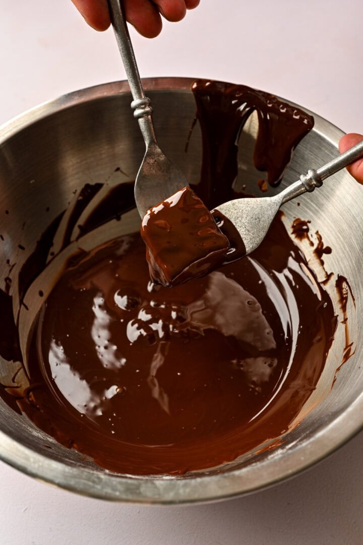 After coating piece of honeycomb in chocolate. 