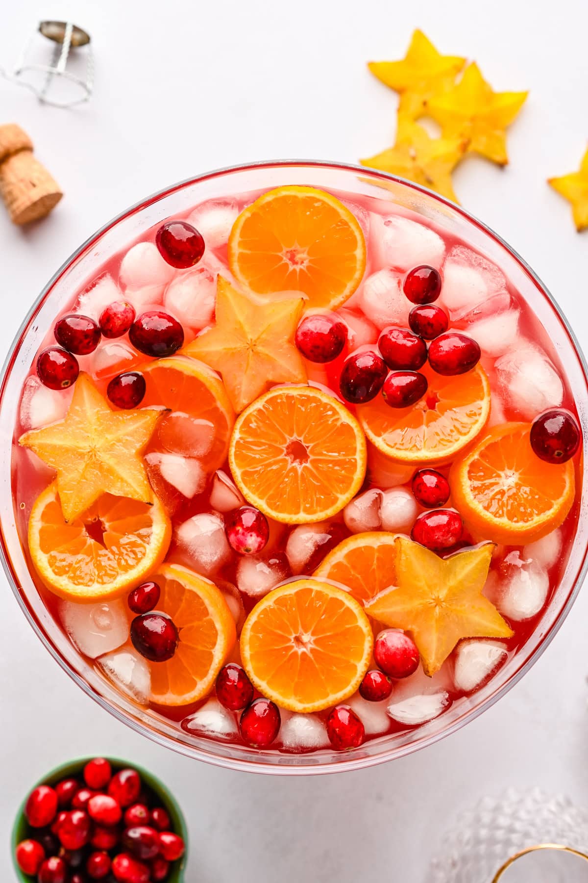 Overhead view of jingle juice christmas punch garnished with orange slices, cranberries and star fruit.