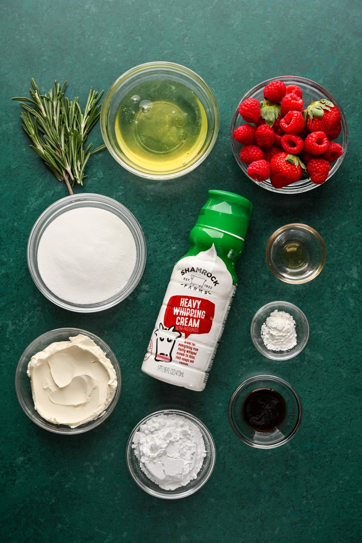 Overhead view of ingredients for meringue wreath on green backdrop.