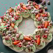 Fresh berry decorated cake with strawberries, raspberries, and greenery, perfect for special occasions.