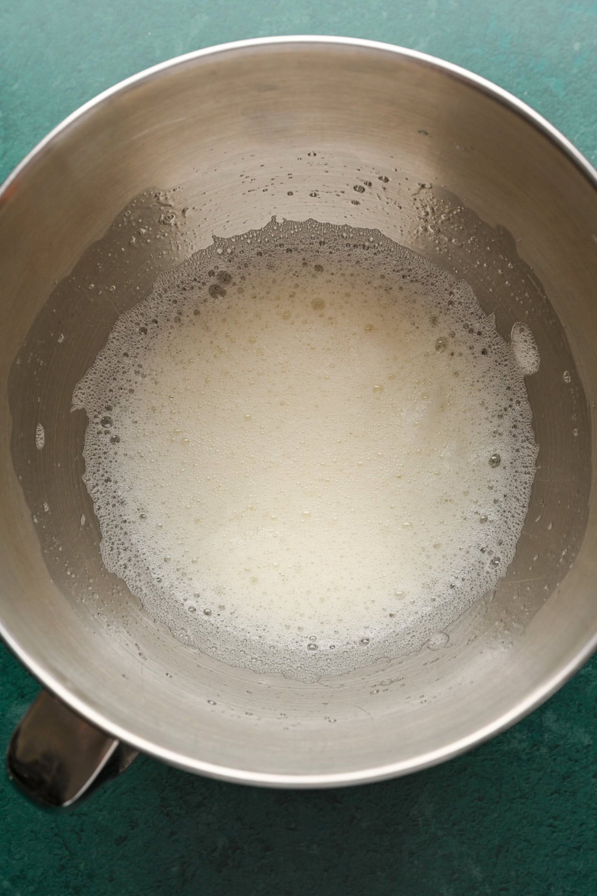 Foamy egg whites in mixing bowl.