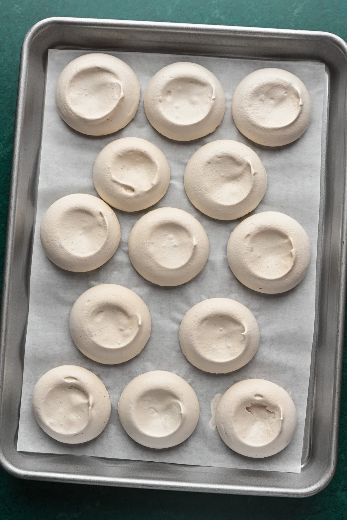 Small meringues on baking sheet. 