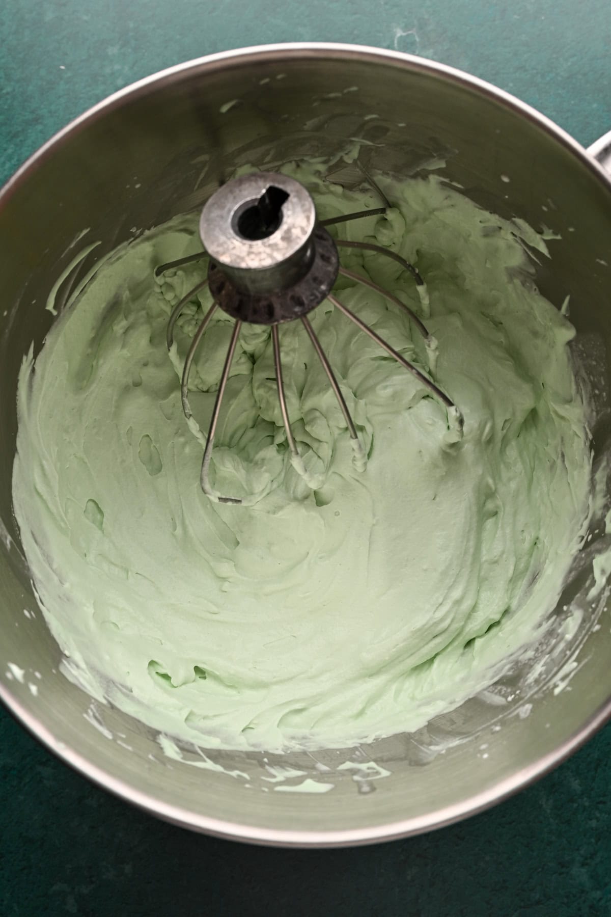 Green whipped cream in a mixing bowl.