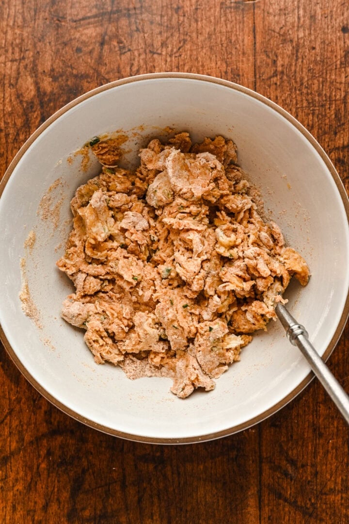 Shaggy dough in a bowl after it was mixed together.