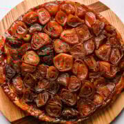 Sweet caramelized onions on a wooden serving board, perfect for savory dishes or toppings.