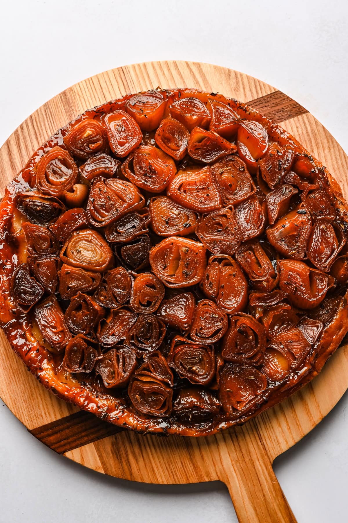 Finished shallot tarte tatin on a cutting board.
