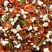 Homemade beet carpaccio with crumbled cheese and fresh herbs.