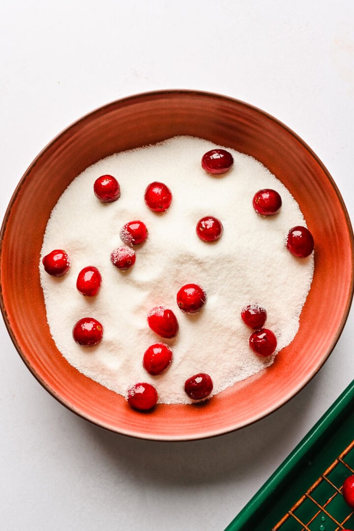 Cranberries in a bowl of sugar.