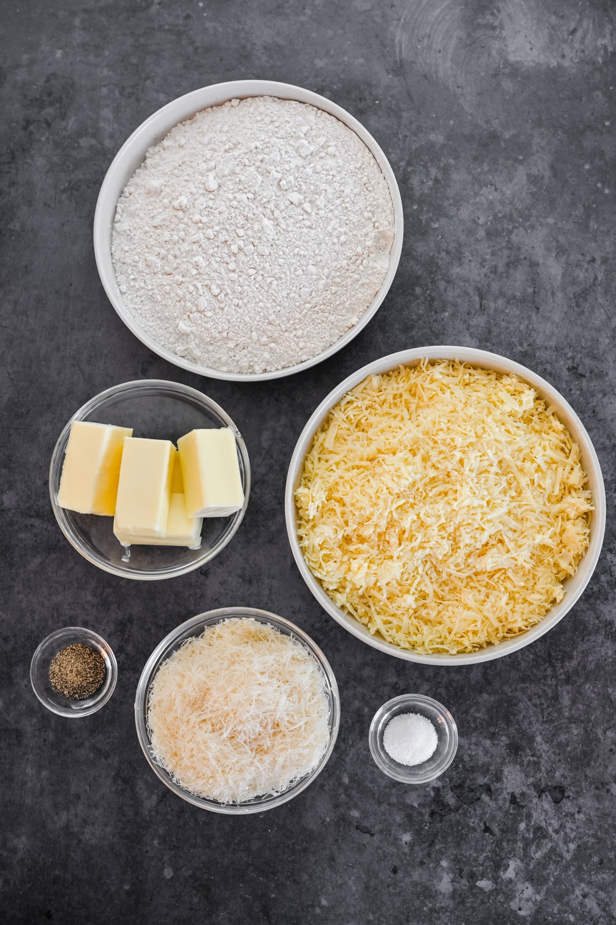 Overhead view of ingredients for white cheddar spritz crackers. 