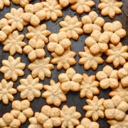 White Cheddar Parmesan Spritz crackers on a sheet pan.