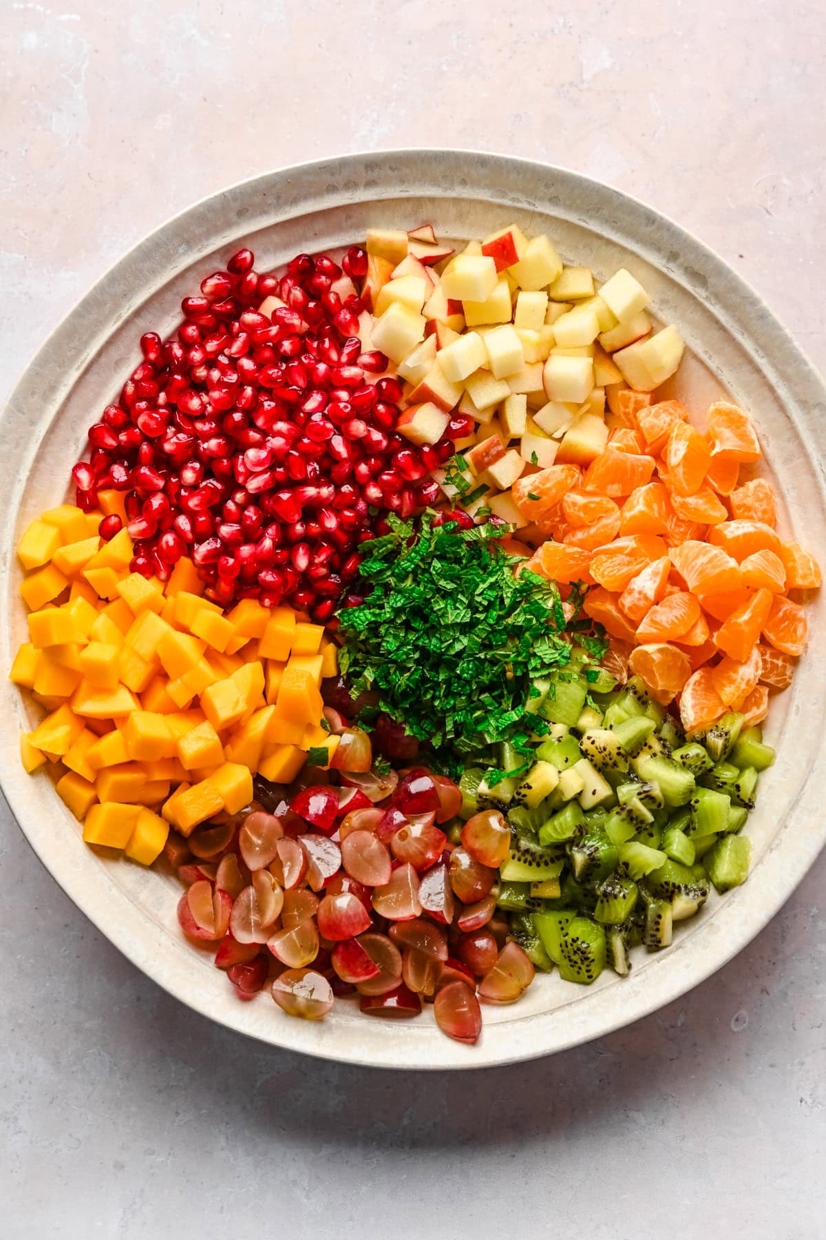 Winter fruit salad ingredients in large mixing bowl before mixing. 