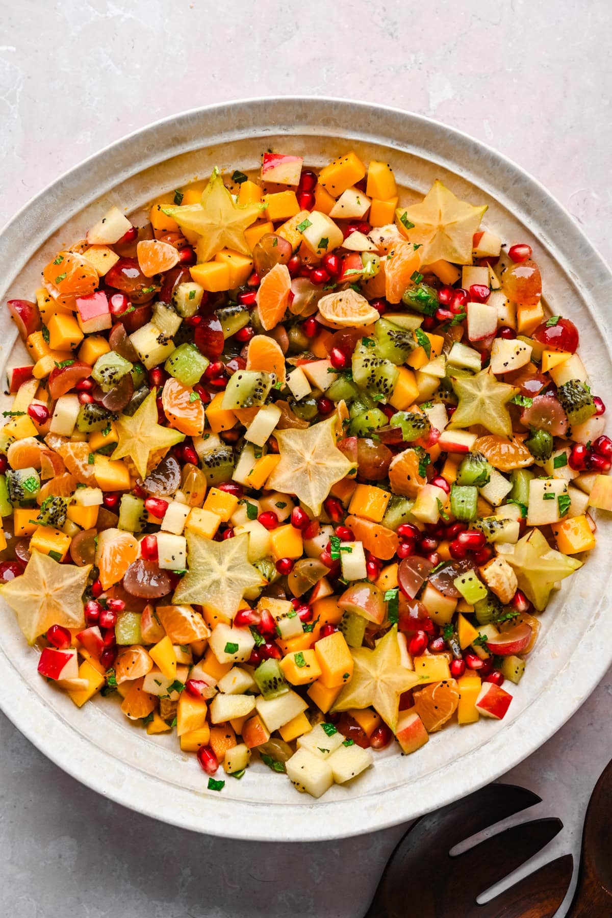 Overhead view of winter fruit salad in a large bowl.