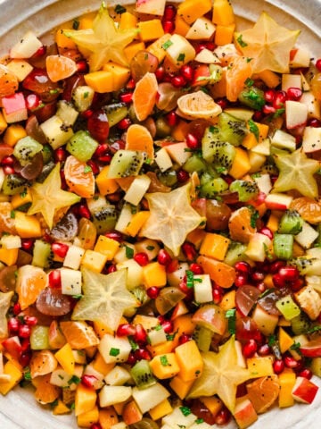 Overhead view of winter fruit salad in a large bowl.