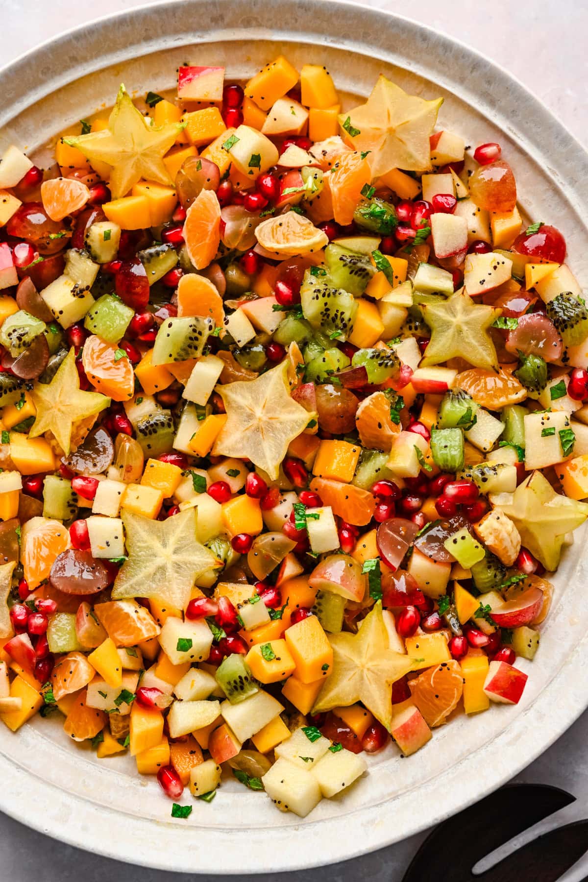 Overhead view of winter fruit salad in a large bowl.