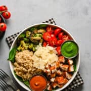 Crispy chicken salad with cherry tomatoes, broccoli, quinoa, and green dressing.