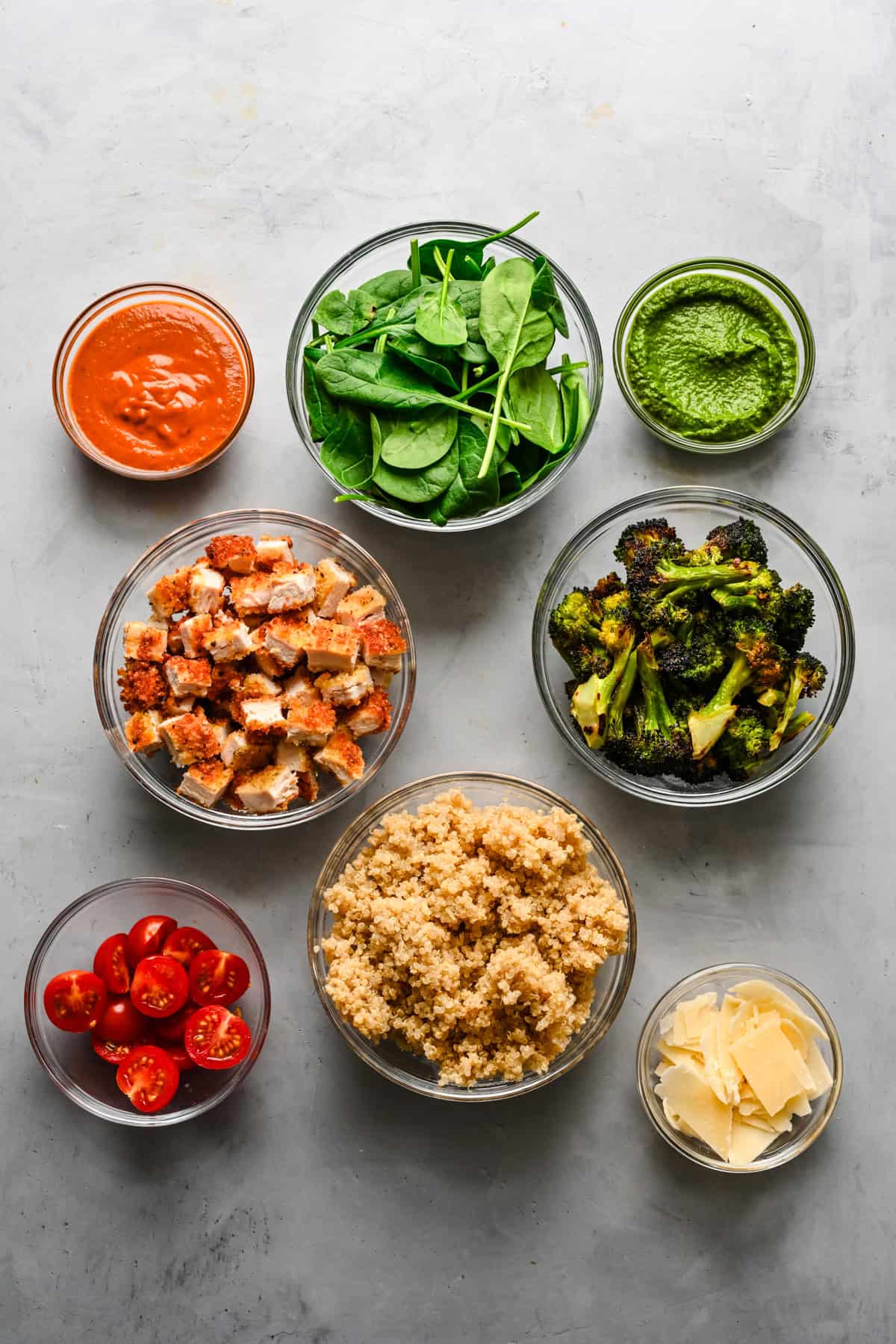 Overhead view of chicken pesto parm bowl ingredients.
