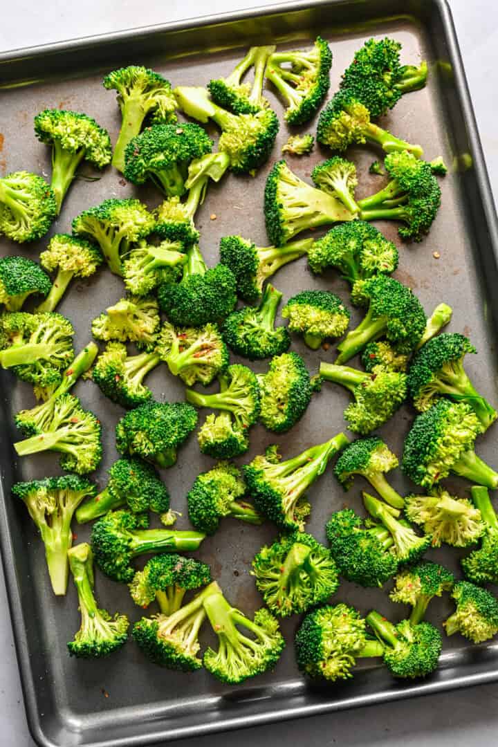 Overhead view of broccoli on a sheet pan.
