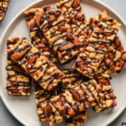 Overhead view of nut bars on a plate.