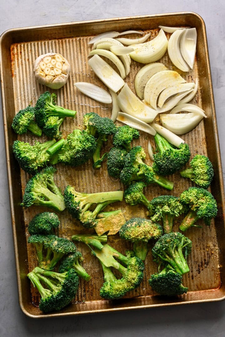 Overhead view of broccoli and onions before roasting.