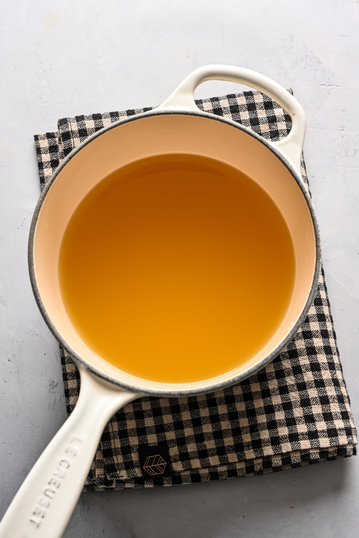 Overhead view of broth in a pot.