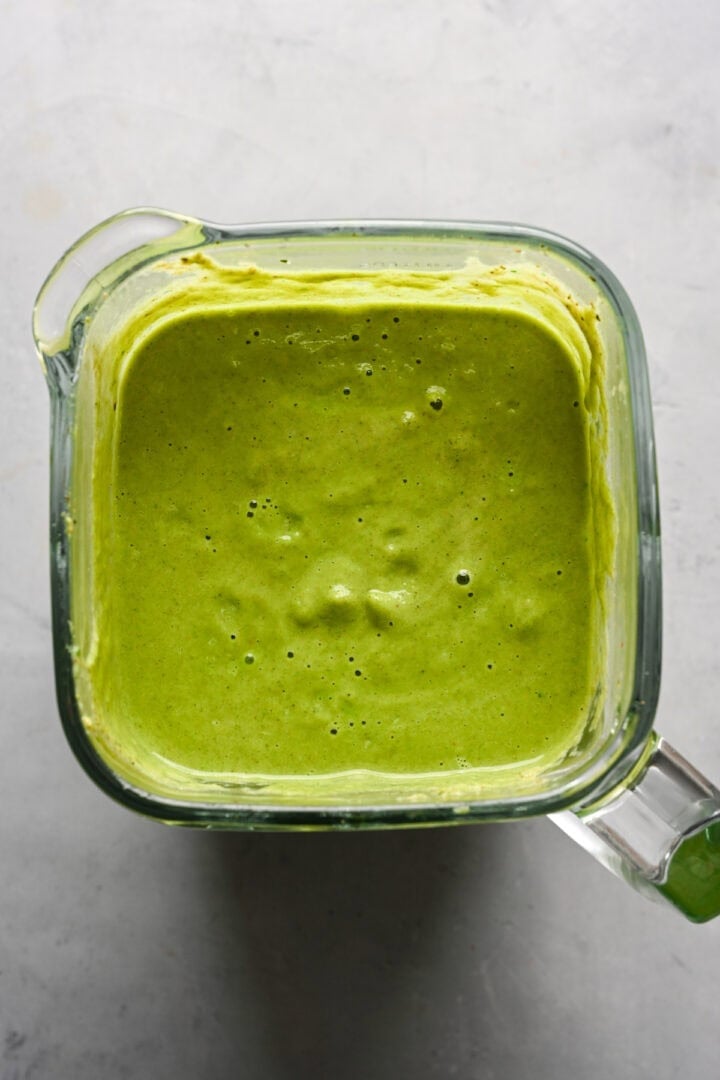 Overhead view of broccoli soup in a blender after blending.