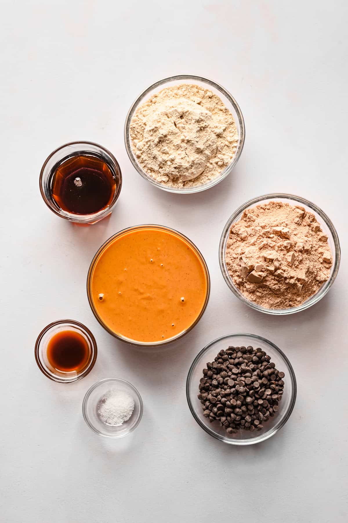 Overhead view of homemade protein bar ingredients, including protein powder and peanut butter.