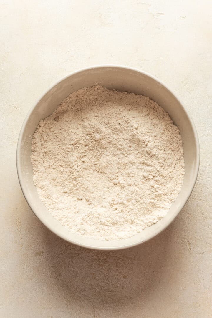 Dry mixture for carrot cake scones in a mixing bowl.