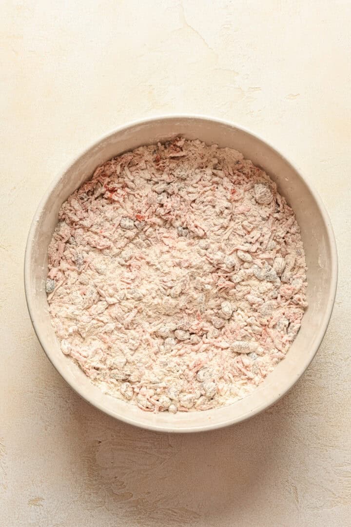Dry mixture for carrot cake scones in a mixing bowl.