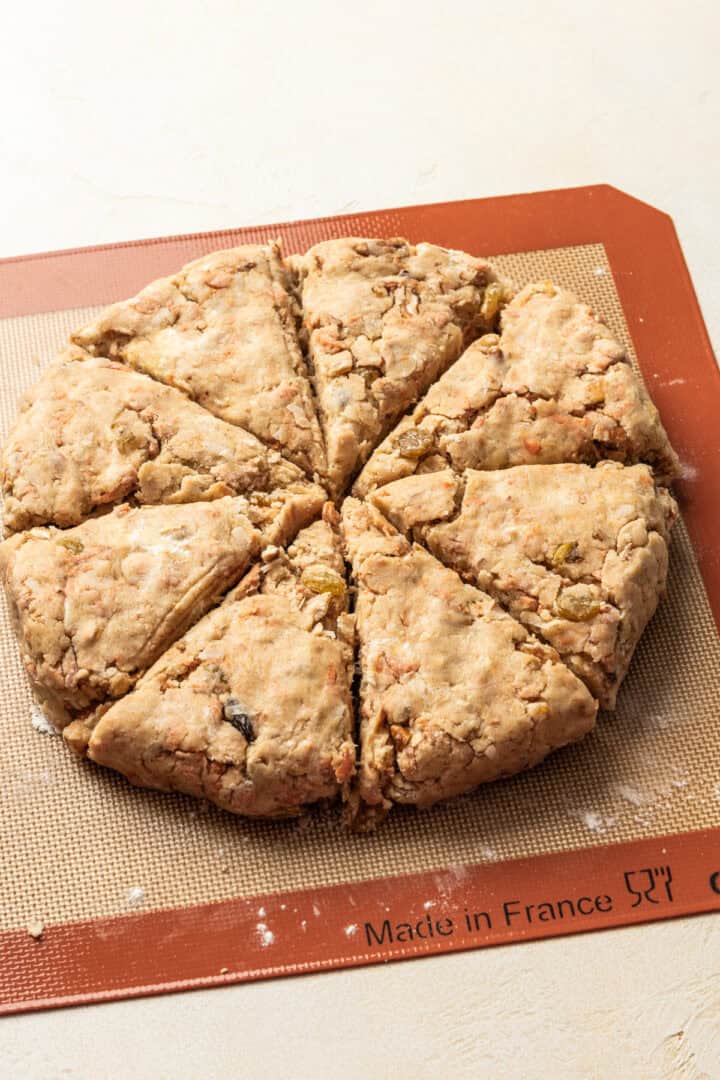 Scone dough in a circle on baking sheet cut into 8 scones.