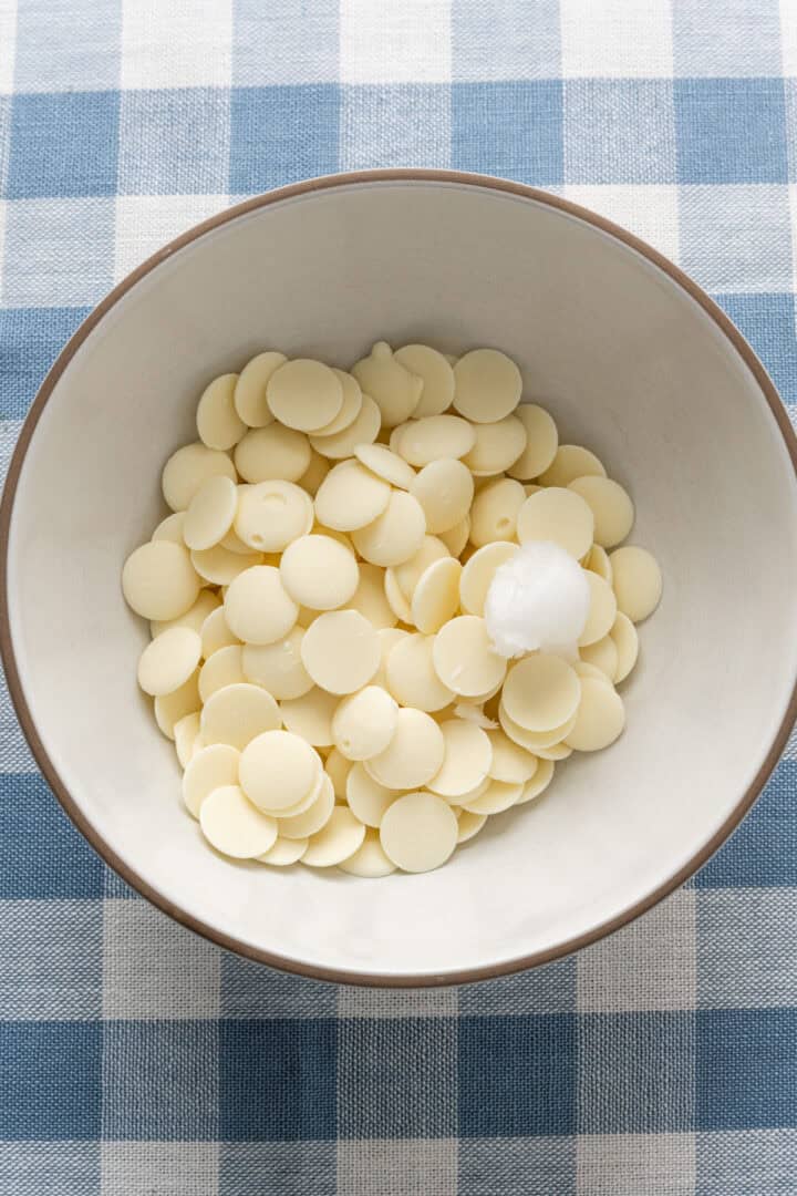 white chocolate wafers and coconut oil in a bowl before melting.
