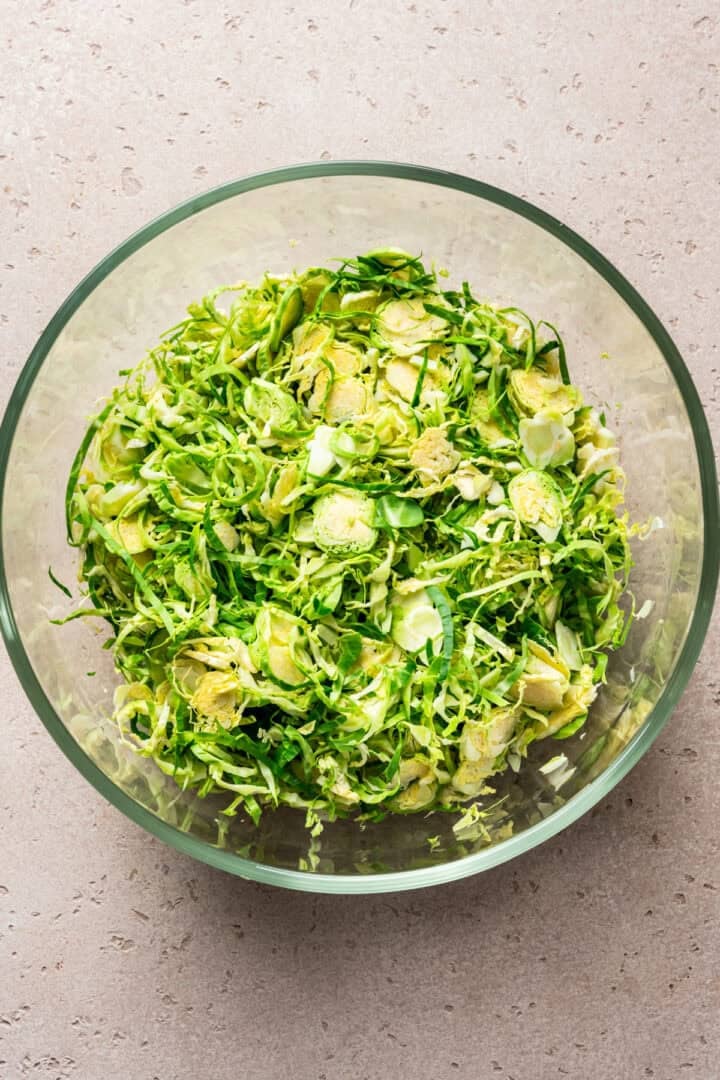 shaved brussels sprouts in a large bowl.