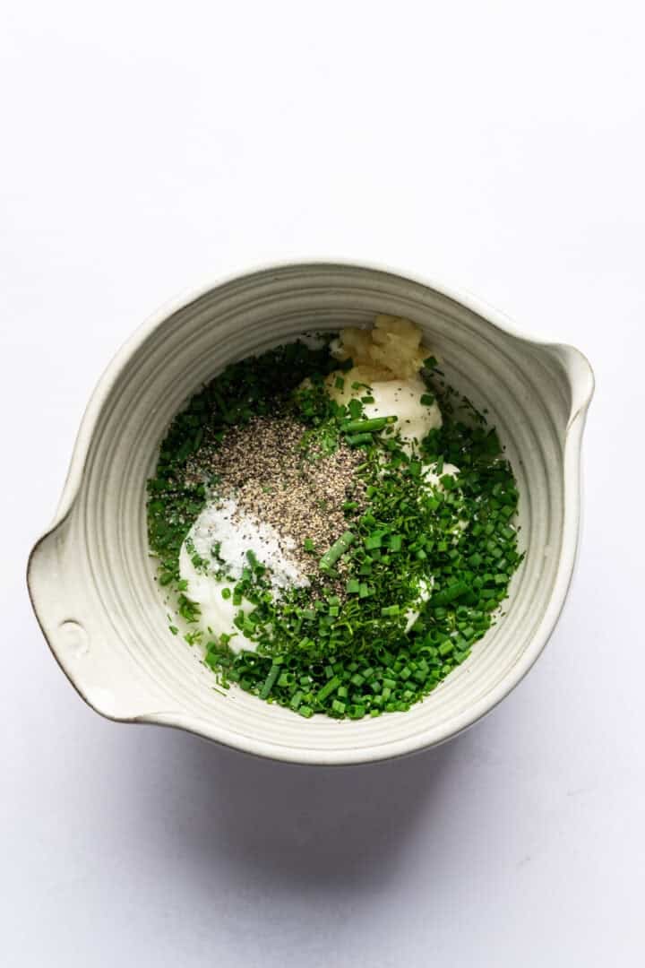 Overhead view of dressing ingredients in a bowl.