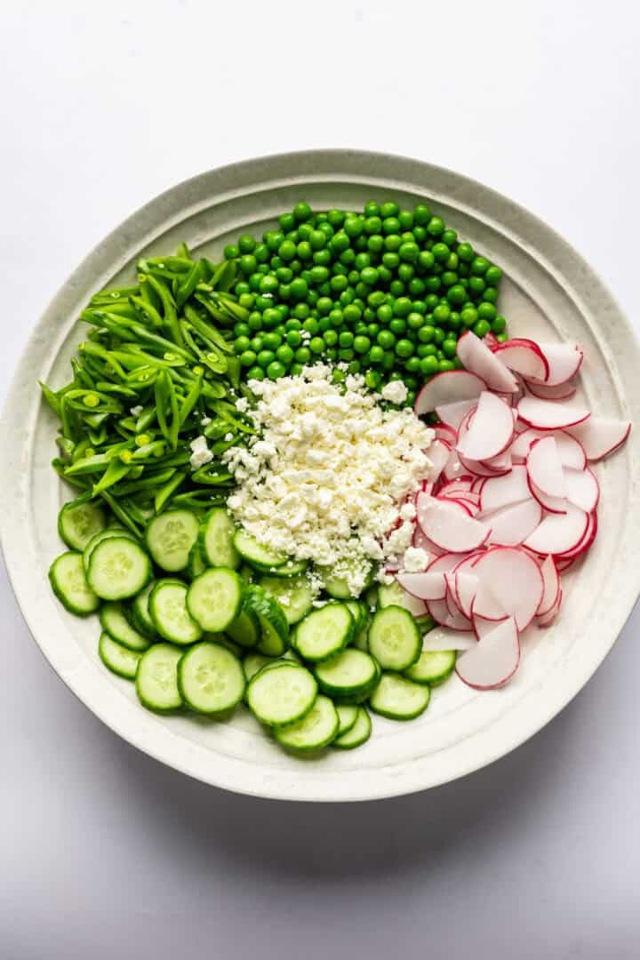 Overhead view of pea salad ingredients before being tossed together.