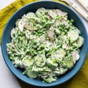 Overhead view of creamy cucumber pea salad in a bowl.